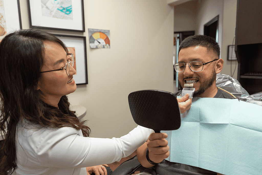 cosmetic dentist in Mansfield, tx, showing veneers to patient