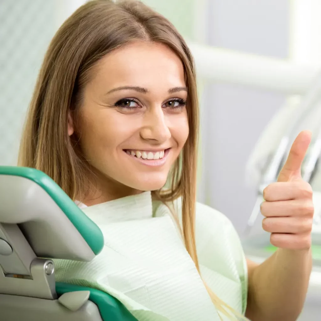 female patient smiling during her visit at a restorative dentist in Arlington