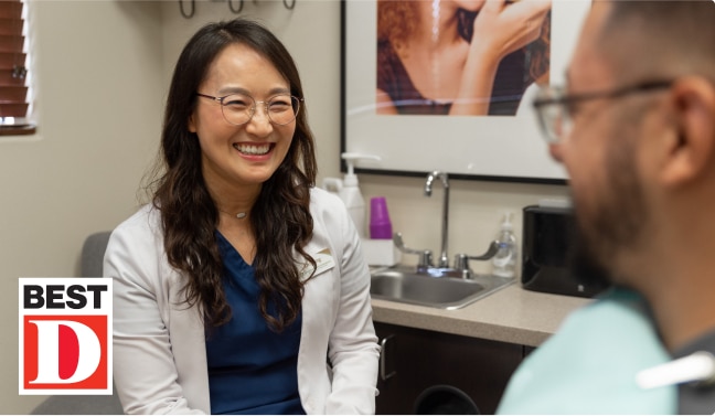 Dr. Jung, won Best dentist in Mansfield for 3 years in a row, smiling at a patient at her Mansfield dentistry.