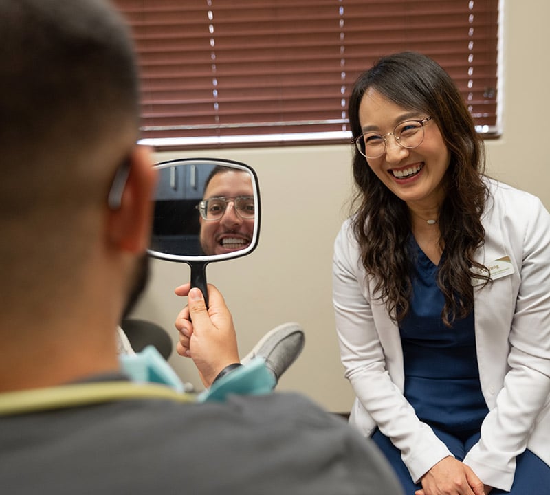 Patient smiling after getting a dental checkup and teeth cleaning in Mansfield, TX.