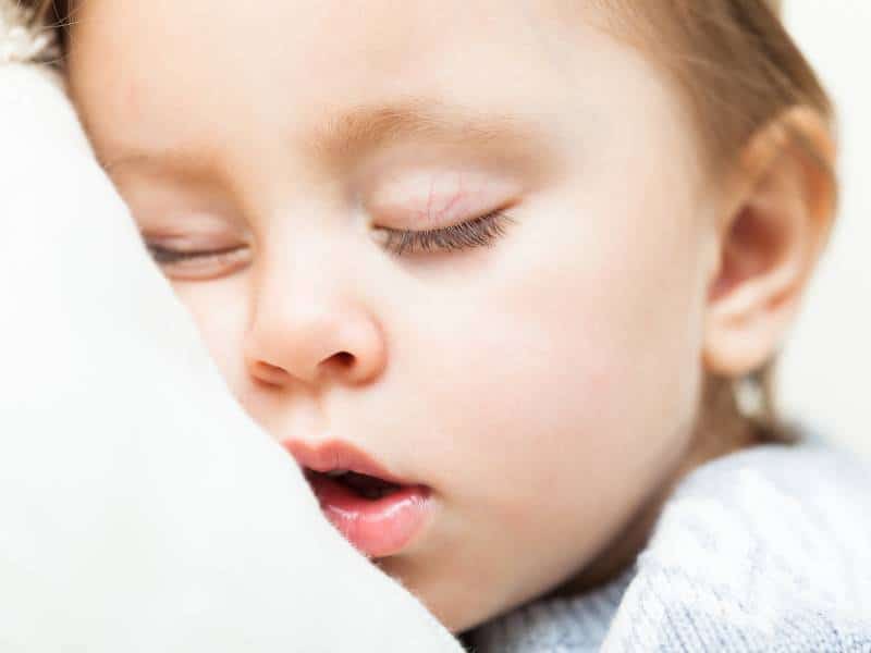 A young child mouth breathing while sleeping