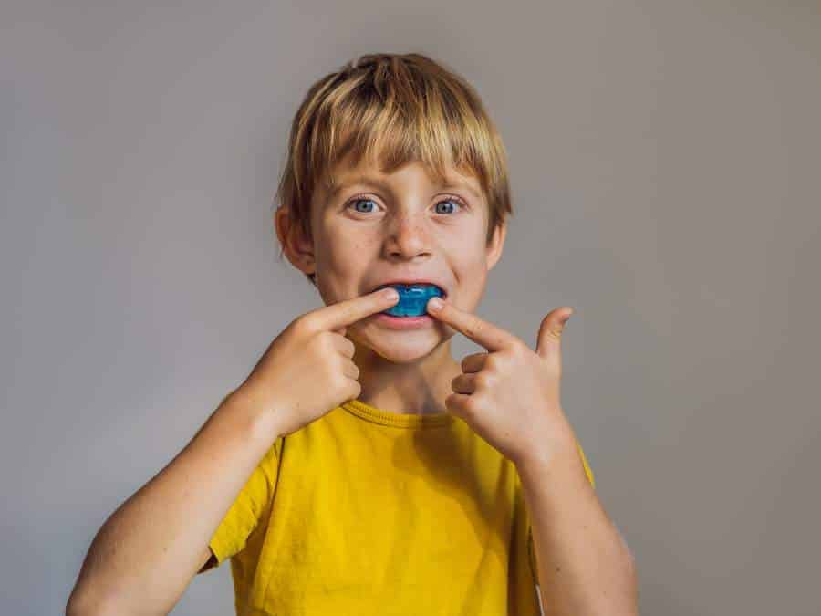 A child wearing a mouth guard to prevent mouth breathing while sleeping in Mansfield, TX