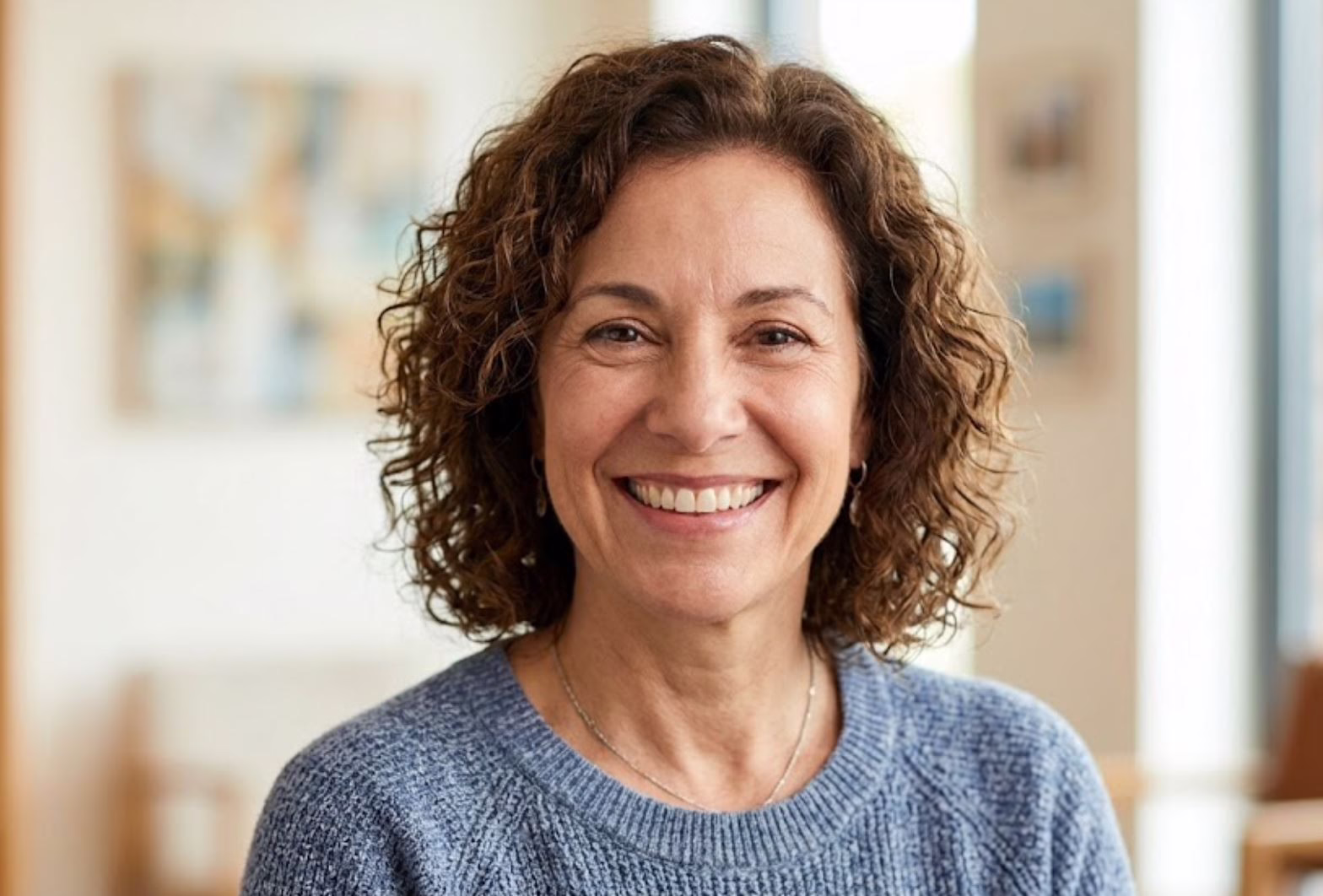 Smiling woman in Mansfield Texas showing healthy dental implants after successful sinus lift surgery at Central Park Dental and Orthodontics